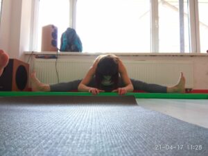 Perfect middle split demonstration in professional dance studio during flexibility training