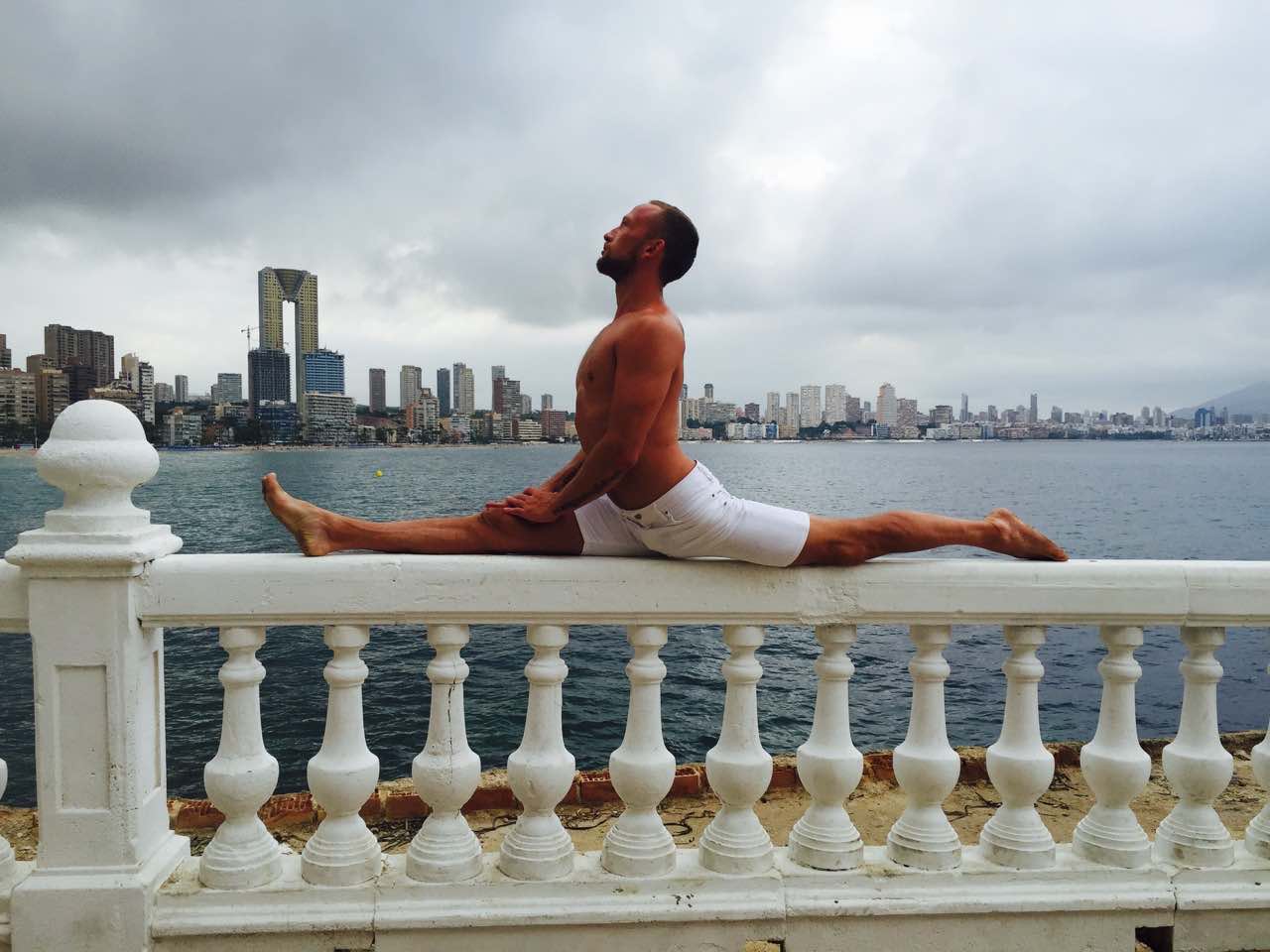Woman performing professional stretching exercises during yoga fitness training session